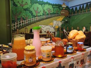 a table topped with different types of food and drinks at Pousada Encanto e Magia in São Thomé das Letras