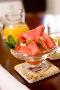 a glass bowl of watermelon and orange juice on a table at Lisson Grove in Mount Tamborine