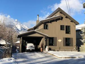 a house with a car parked in front of it in the snow at Mountain View Bed & Breakfast in Banff