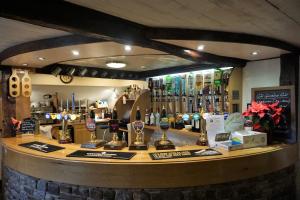 a counter in a bar with a lot of bottles of wine at The Shepherds Inn, Langwathby in Penrith