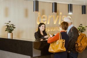 a group of people standing around a reception desk at Spa Tervis in Pärnu