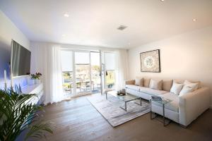 a living room with a couch and a tv at View & Garden Villa Schauenstein in Schauenstein