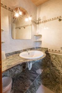 a bathroom with a sink and a mirror at Sa Cunia in Campos