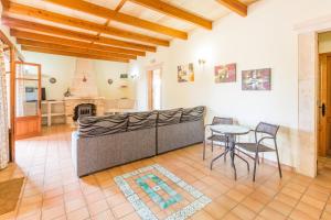 a living room with a couch and a table and chairs at Sa Cunia in Campos