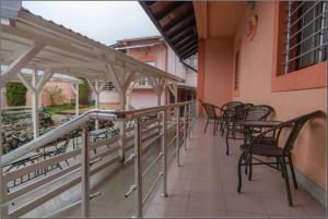 a balcony with chairs and tables on a building at Olympic Residence Hotel in Prokuplje