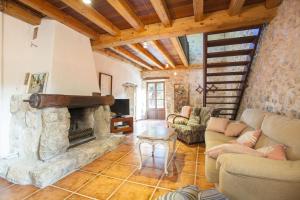 a large living room with a stone fireplace at Can Guillo in Pollença