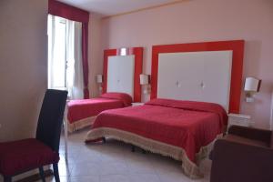 Un pat sau paturi într-o cameră la Albergo Panorama