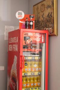a red refrigerator filled with lots of drinks at Pensión San Isidro in Madrid