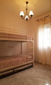 a bedroom with two bunk beds and a chandelier at Lovely House with views in Marina del Este in Almuñécar