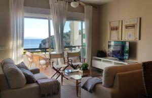 a living room with a couch and a tv at Lovely House with views in Marina del Este in Almuñécar