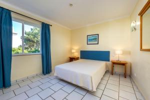 a bedroom with a bed and a large window at Club Ouratlantico in Albufeira +51 photos