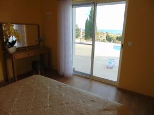 a bedroom with a bed and a large sliding glass door at Villa Altavista El Campello, Alicante in El Campello +87 photos
