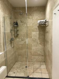 a bathroom with a shower with a glass door at The Old Rectory in Jarrow