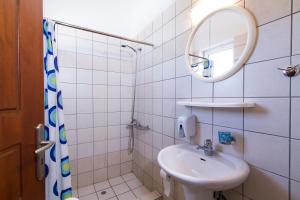 a bathroom with a sink, toilet and mirror at Mediterranean Hotel Studios Apartments in Kissamos