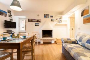 a living room with a table and a couch at Casa dell'Avventura in Castelmezzano