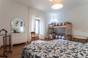 a bedroom with a bed and a bunk bed at Casa dell'Avventura in Castelmezzano