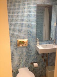 ein blau gefliestes Bad mit WC und Waschbecken in der Unterkunft Studio in the heart of Alfama in Lissabon