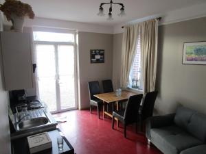 a living room with a dining room table and chairs at Mon Doux Repos in Cambrai