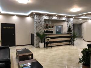 a lobby with a waiting area with a tv in it at Hotel Elit in Kirkovo +85 photos