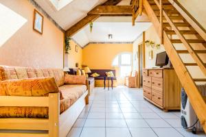 a living room with a couch and a tv at gite de pontgibaud in Lathuile