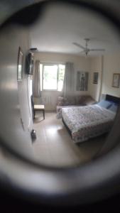 a view of a bedroom with a bed and a window at Apartamento Praia Santos in Santos