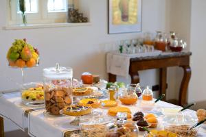 a table filled with different types of pastries and desserts at ai Santinelli in Lucca