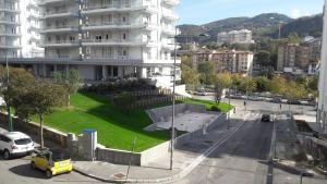 a building with a green lawn in front of a street at smArt B&B in Salerno