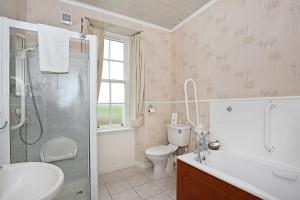 a bathroom with a toilet sink and a shower at The Spindrift Guest House in Anstruther