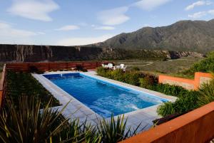 a swimming pool with a view of the mountains at Entre montañas y rio, Cacheuta in Ciudad Lujan de Cuyo