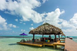 a pier with a hut on the water at X'tan Ha- The Waterfront in San Pedro