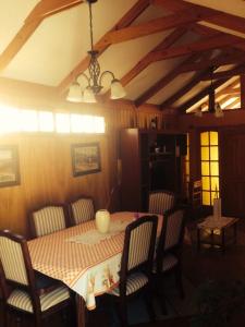 a dining room with a table and chairs and a ceiling at Casa La Serena in La Serena