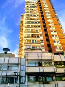 a tall building with windows and a street light at Sunny Apartment in Belgrade