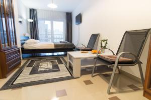 a room with a bed and a table and a chair at Bubble Apartments in Kraków
