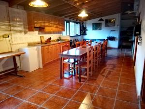 a kitchen with a table and chairs in it at Casa La Montaña in El Cedro