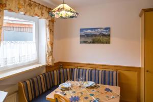 a dining room with a table and chairs and a window at Ferienwohnung Zobl in Füssen