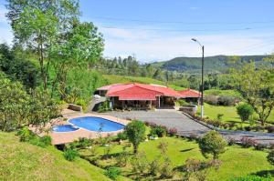 a house with a swimming pool in a yard at Finca La Toscana in Pereira