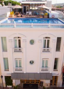 a white building with a swimming pool on top of it at GHL Arsenal Hotel in Cartagena de Indias