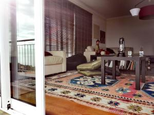 a living room with a couch and a table at Zen Caniço Apartment in Caniço