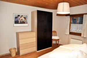 a bedroom with a black door and a bed at Chasa Sager 4 in Scuol