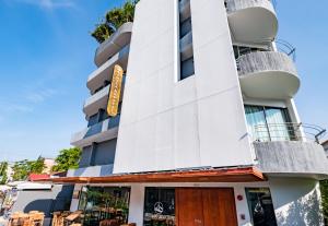 a large building with a large window on top of it at Kamala Resotel, SHA Extra Plus in Kamala Beach