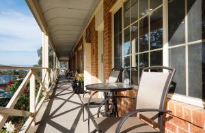 a patio area with a patio table and chairs at Commercial Golf Resort in Albury
