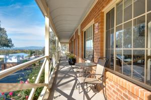 a balcony with a table and chairs on a building at Commercial Golf Resort in Albury