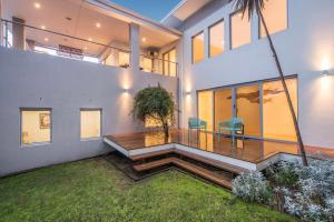 a house with a deck with two chairs on it at Calm Waters in Dunsborough