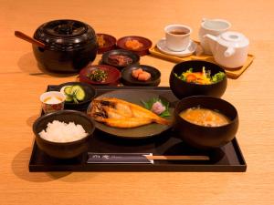 a plate of food on a table with bowls of food at UAN kanazawa in Kanazawa