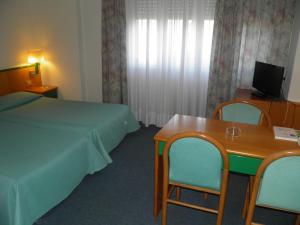 Postel nebo postele na pokoji v ubytování Hotel Ramoverde