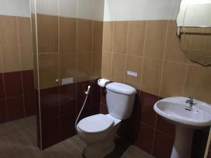 a bathroom with a toilet and a sink at Room Place in Chumphon