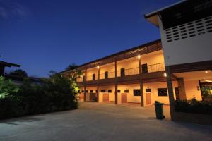 an exterior view of a building at night at Room Place in Chumphon
