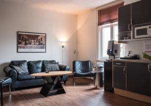 a living room with a couch and a table at Hotel Åberg Centralhotellet in Tranås