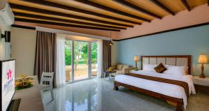 a bedroom with a bed and a large window at Sokha Beach Resort in Sihanoukville
