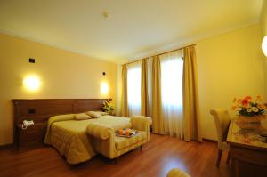 Posteľ alebo postele v izbe v ubytovaní Hotel Panoramic Montepulciano